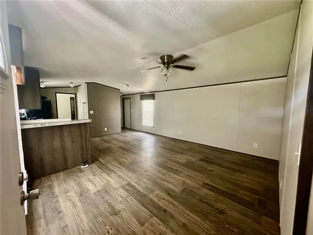 a view of a kitchen with a sink and wooden floor