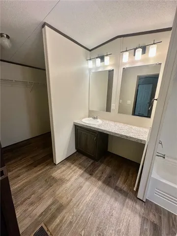 a en suite bathroom with a sink a mirror and a shower