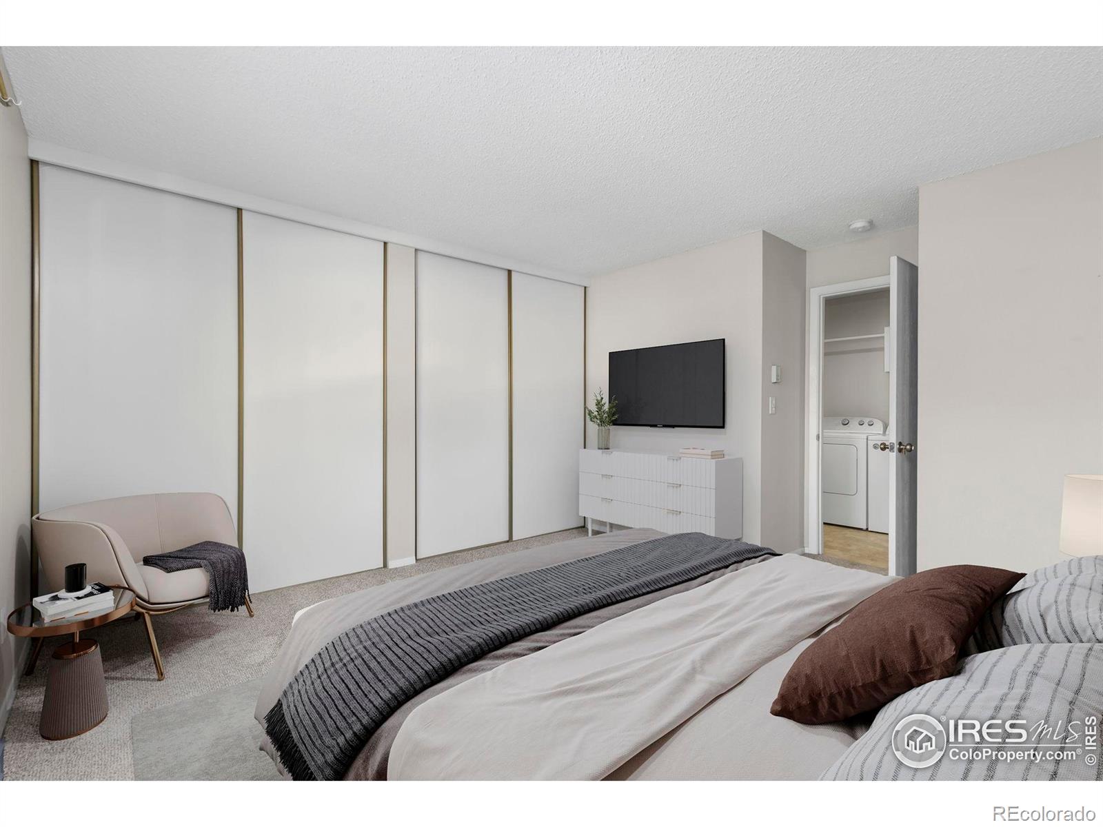 925 Columbia Road Fort Collins, CO 80525 - Photo 13 of 24 a bedroom with a bed and a flat screen tv