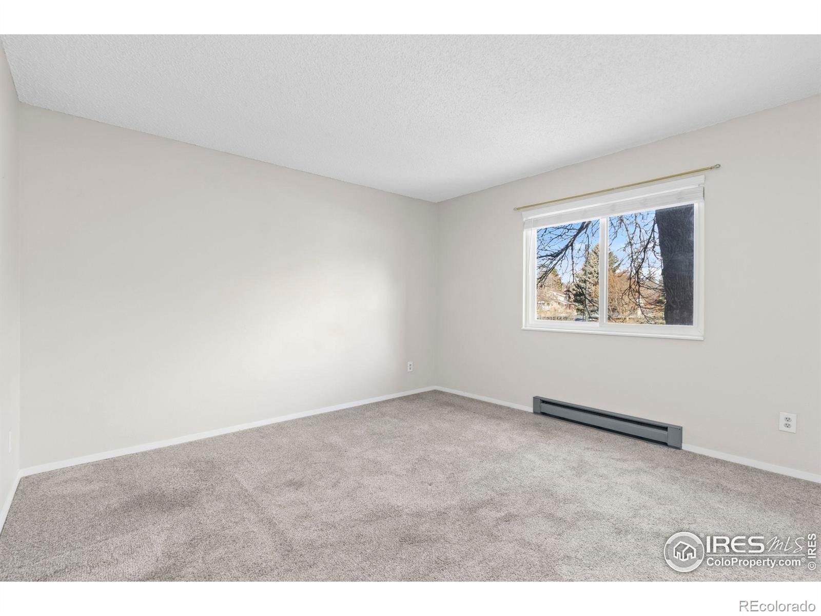 925 Columbia Road Fort Collins, CO 80525 - Photo 14 of 24 an empty room with painting on the wall