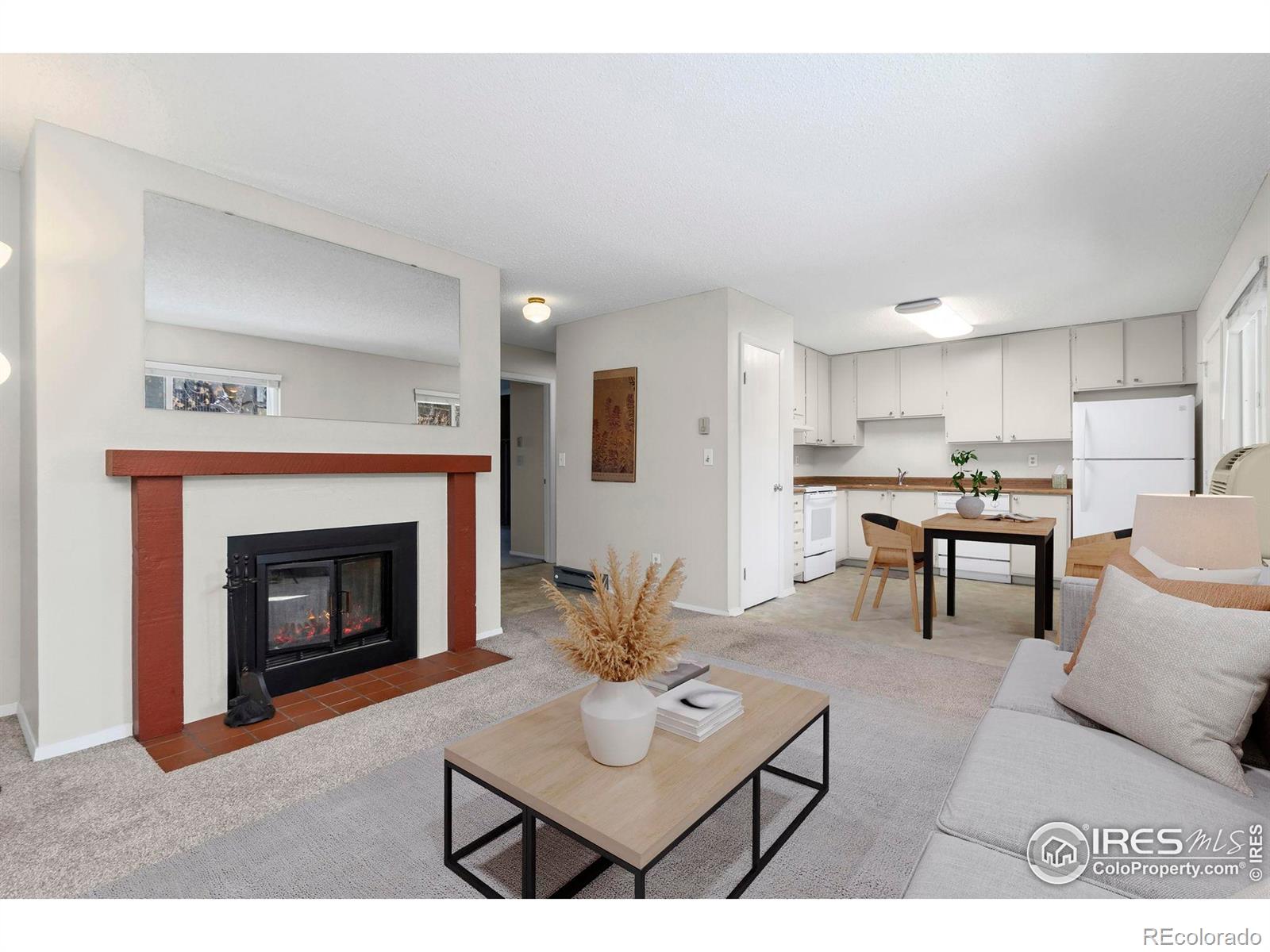 925 Columbia Road Fort Collins, CO 80525 - Photo 2 of 24 a living room with furniture a fireplace and kitchen view