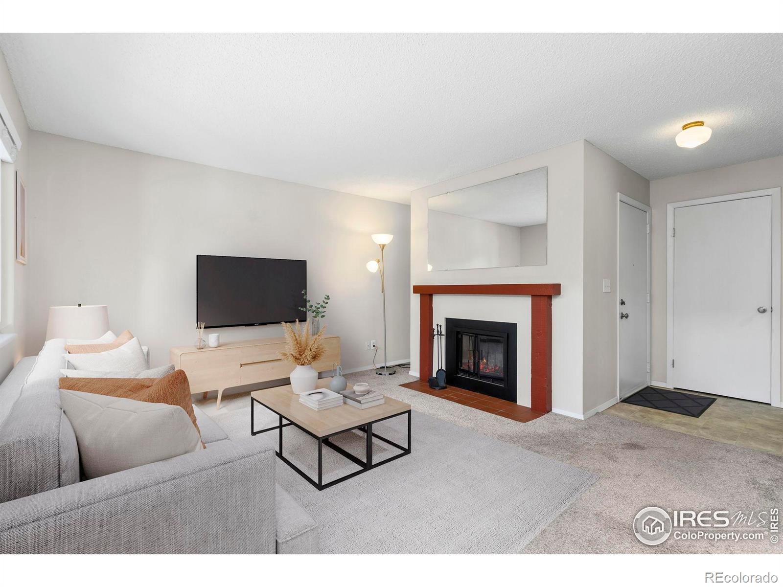 925 Columbia Road Fort Collins, CO 80525 - Photo 3 of 24 a living room with furniture and a fireplace