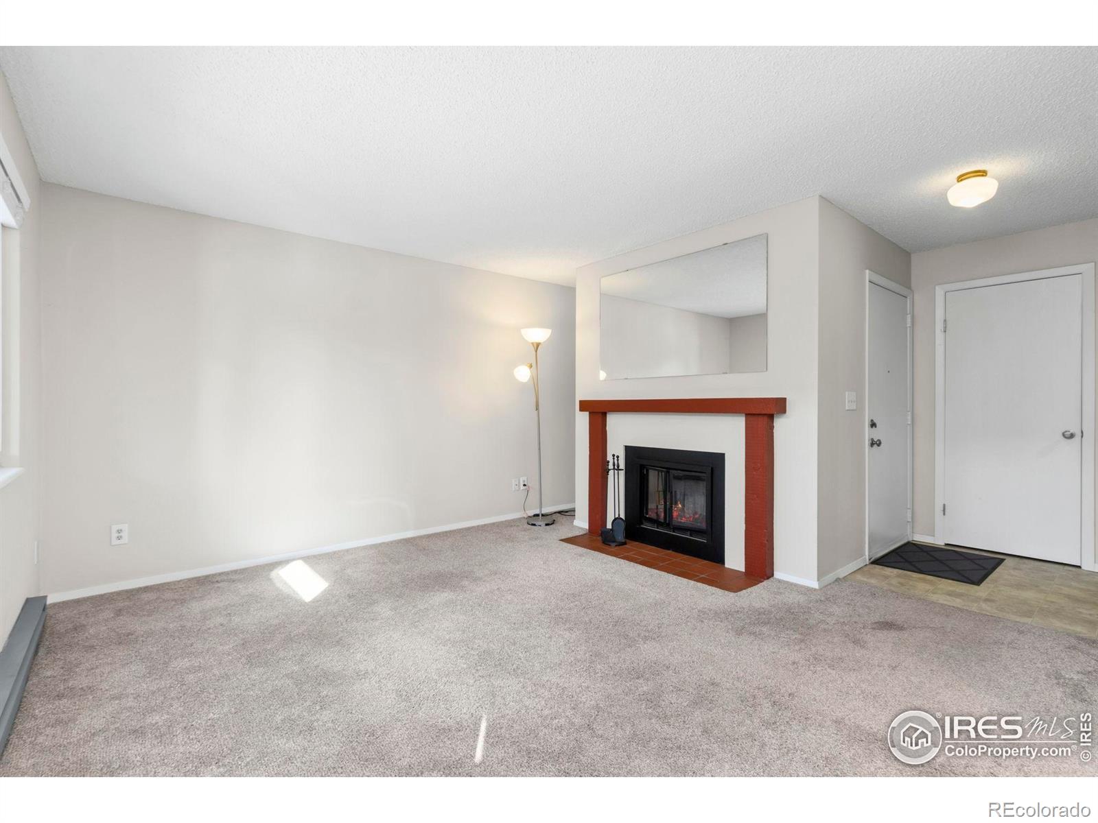 925 Columbia Road Fort Collins, CO 80525 - Photo 5 of 24 a view of an empty room with a fireplace