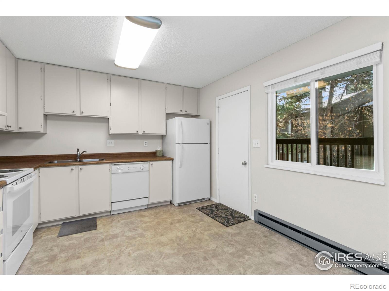 925 Columbia Road Fort Collins, CO 80525 - Photo 8 of 24 a kitchen with a refrigerator and window