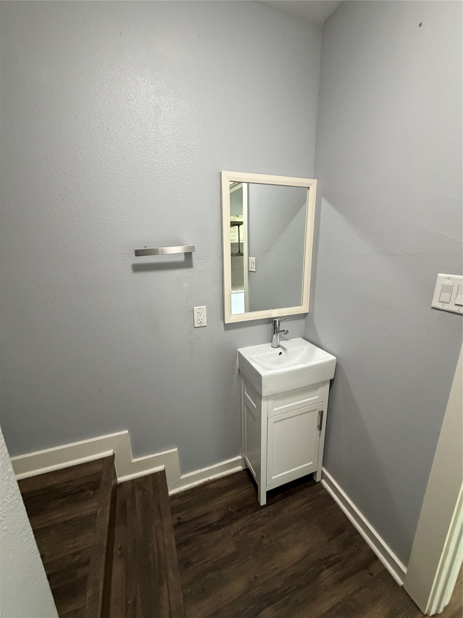 4630 Woodside Street, Unit 2 Houston, TX 77023 - Photo 6 of 11 a bathroom with a sink a mirror and vanity