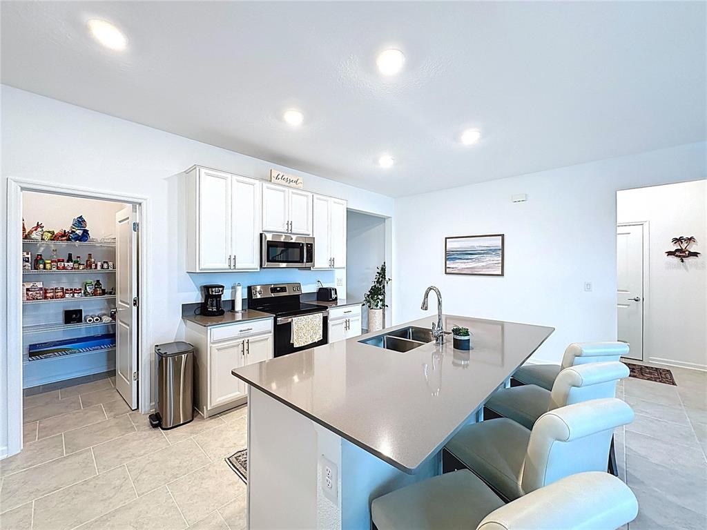 4190 Bull Street St. Cloud, FL 34772 - Photo 17 of 98 a living room with furniture a kitchen view and a window