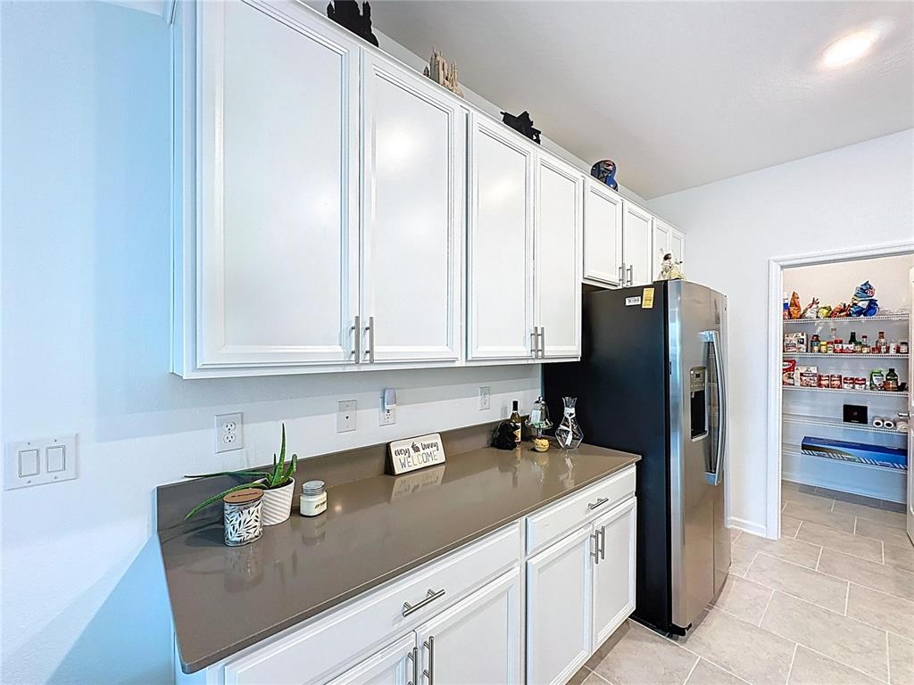 4190 Bull Street St. Cloud, FL 34772 - Photo 18 of 98 a kitchen with stainless steel appliances granite countertop a refrigerator and a sink