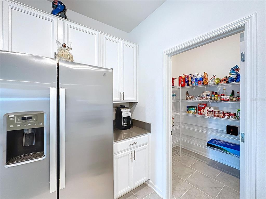 4190 Bull Street St. Cloud, FL 34772 - Photo 19 of 98 a kitchen with stainless steel appliances a refrigerator and a sink
