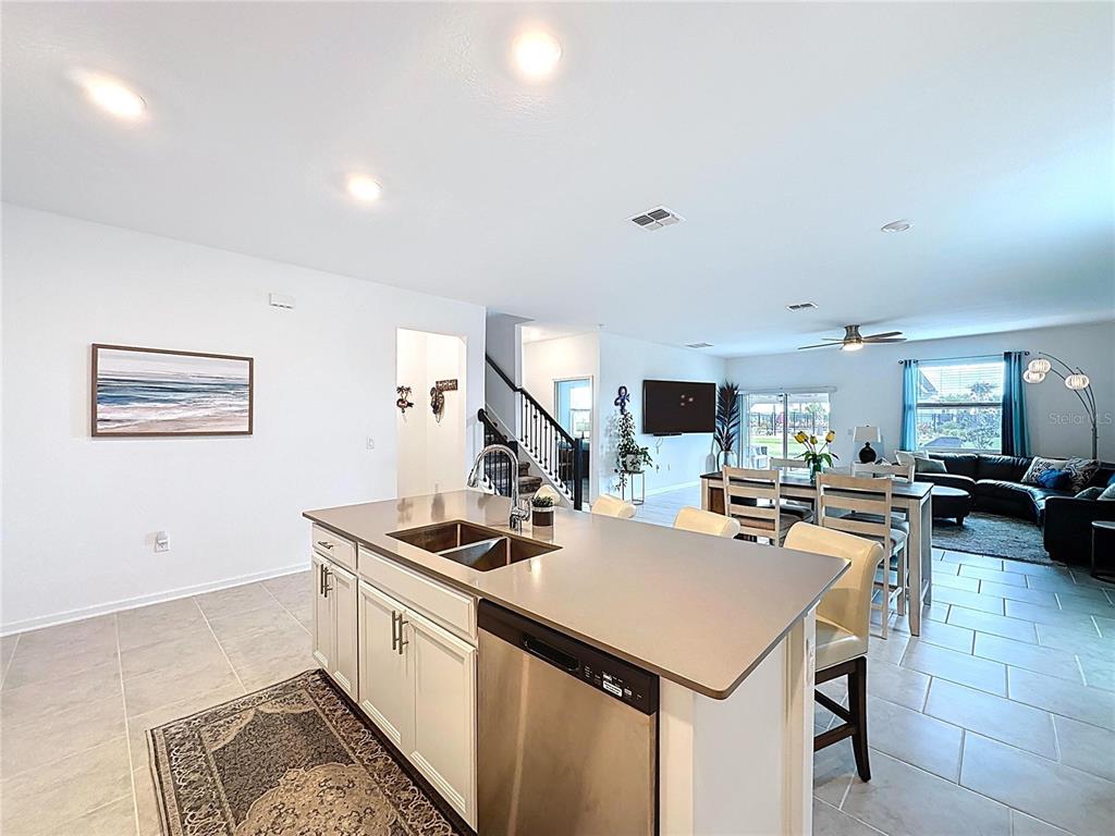 4190 Bull Street St. Cloud, FL 34772 - Photo 24 of 98 a kitchen that has a lot of cabinets a sink and a stove in it