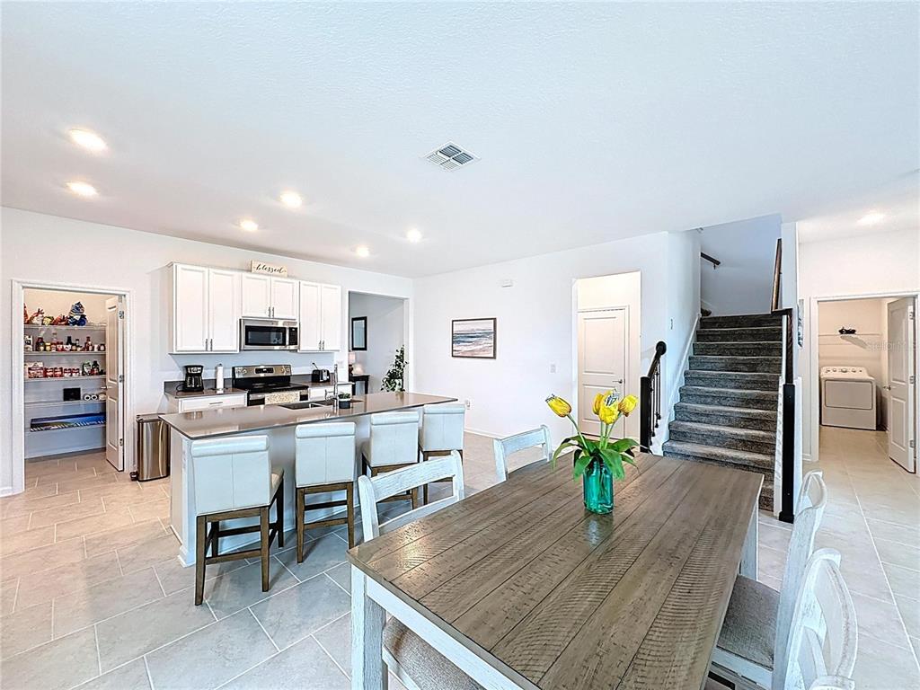4190 Bull Street St. Cloud, FL 34772 - Photo 26 of 98 a living room with kitchen island furniture and a wooden floor