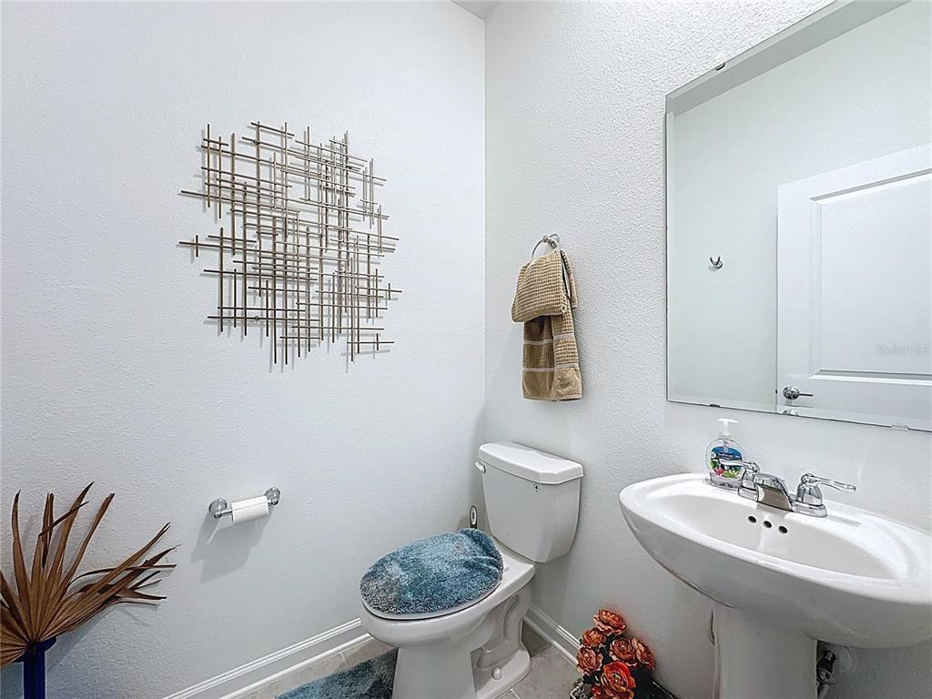 4190 Bull Street St. Cloud, FL 34772 - Photo 30 of 98 a bathroom with a sink toilet and a mirror