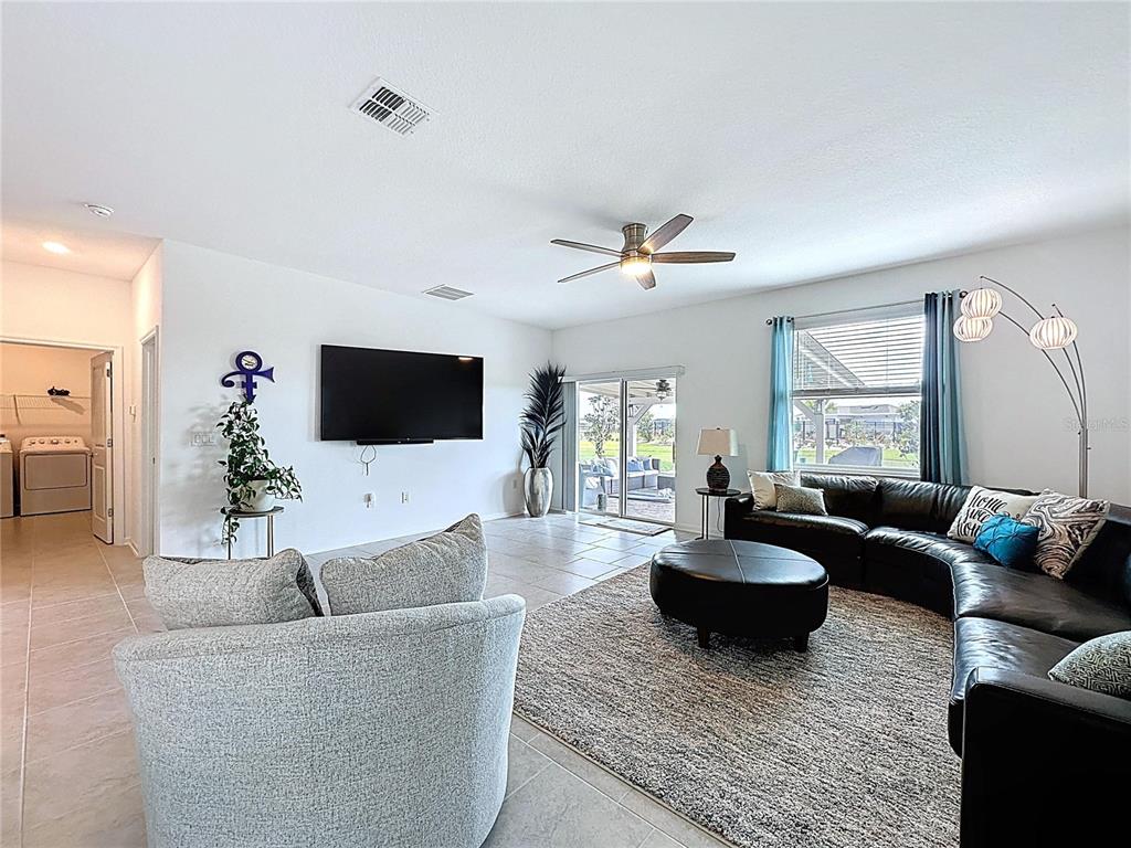 4190 Bull Street St. Cloud, FL 34772 - Photo 32 of 98 a living room with furniture and a flat screen tv