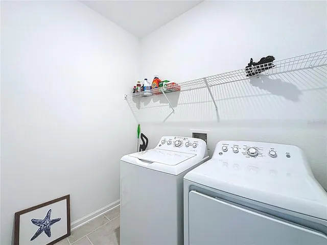 an aerial view of a house with a garden and lake view