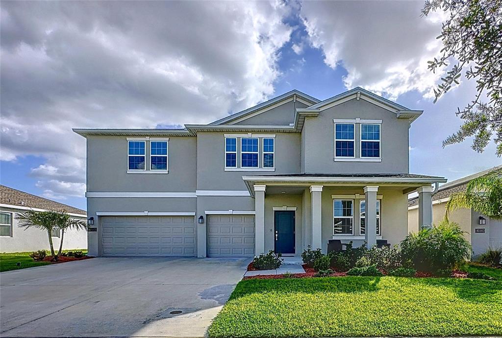 4190 Bull Street St. Cloud, FL 34772 - Photo 6 of 98 a front view of a house with a yard and garage