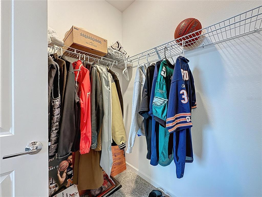 4190 Bull Street St. Cloud, FL 34772 - Photo 63 of 98 a view of walk in closet with clothes and shoes