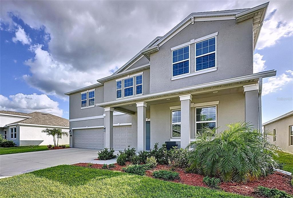 4190 Bull Street St. Cloud, FL 34772 - Photo 8 of 98 a front view of a house with a yard and potted plants