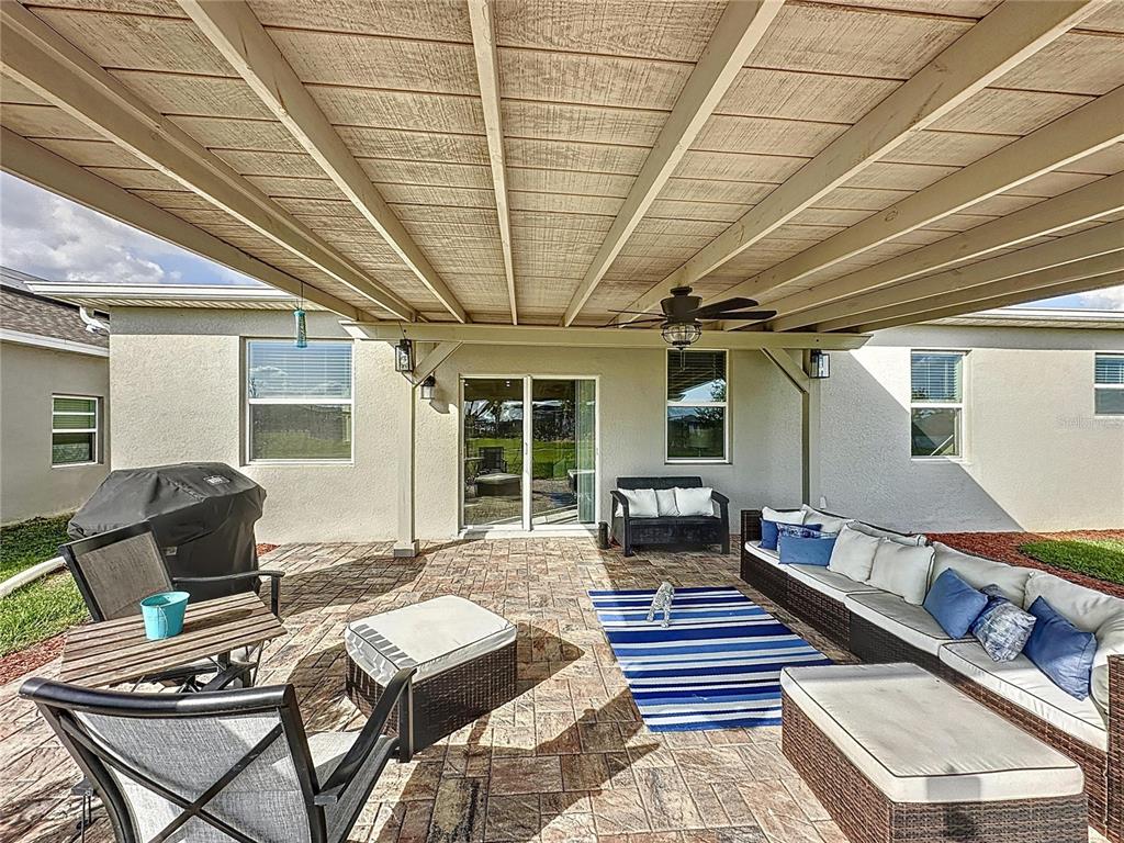 4190 Bull Street St. Cloud, FL 34772 - Photo 83 of 98 a living room with furniture and a floor to ceiling window