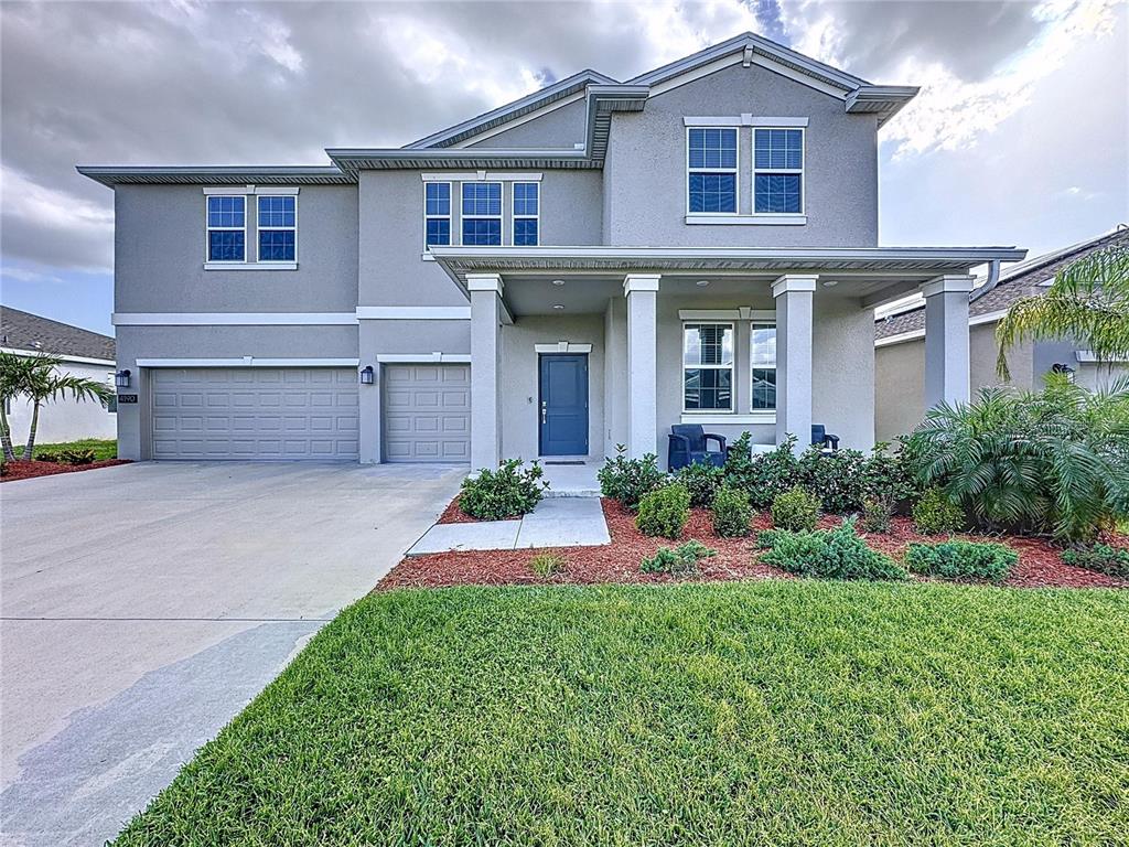 4190 Bull Street St. Cloud, FL 34772 - Photo 9 of 98 a front view of a house with a yard and garage