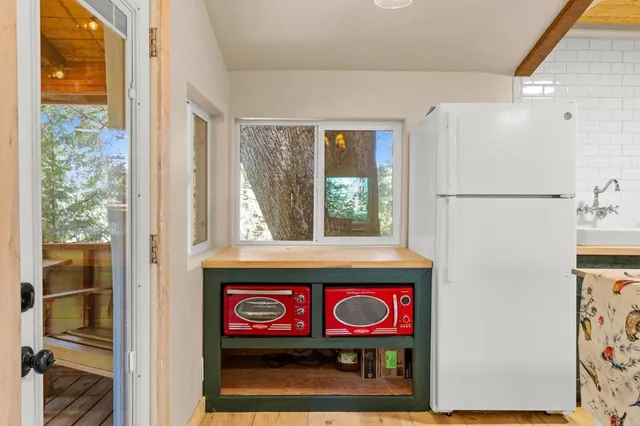 a bathroom with a toilet sink vanity mirror and shower
