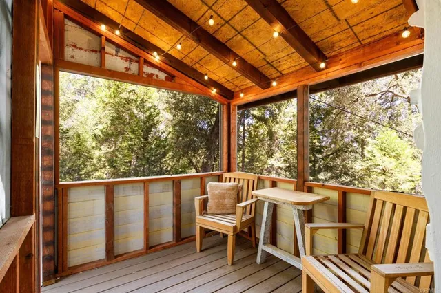 a view of balcony with wooden floor and seating space