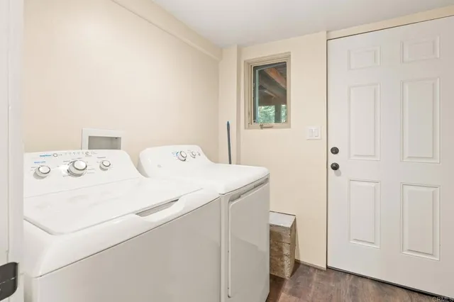 a view of a house with wooden fence and large windows