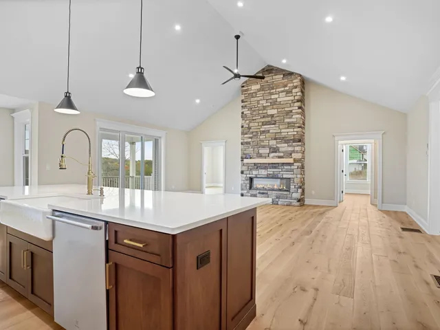 a large kitchen with stainless steel appliances granite countertop a sink and cabinets