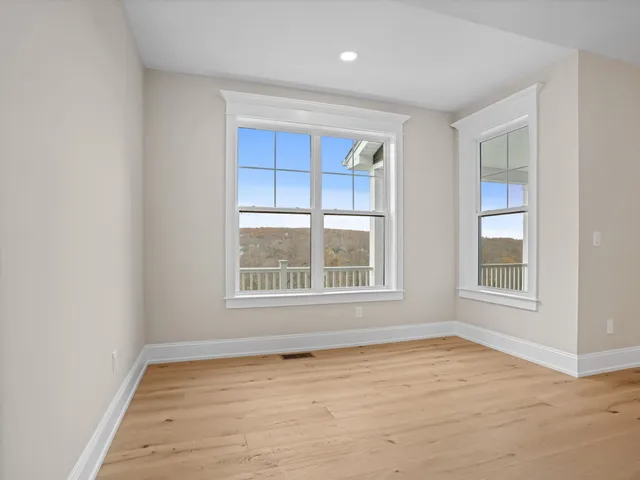 a kitchen with stainless steel appliances granite countertop a stove and a wooden floors