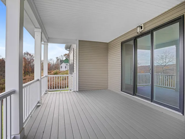 a view of a balcony with wooden floor