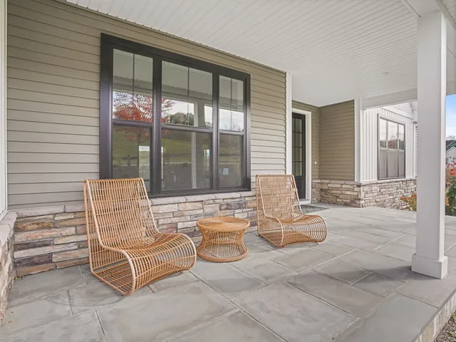 a living room with furniture and large windows