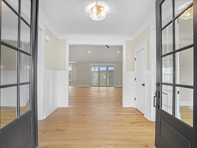 a view of interior space with wooden floor and a window