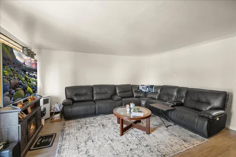 a living room with furniture a flat screen tv and a fireplace