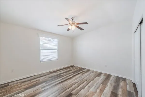 a view of a room with a ceiling fan and a window