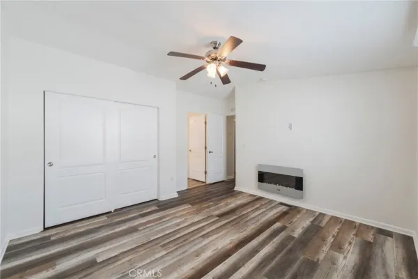 a view of a livingroom with a hardwood floor and a ceiling fan