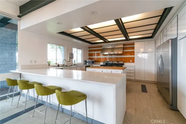a kitchen with stainless steel appliances granite countertop a refrigerator and a stove