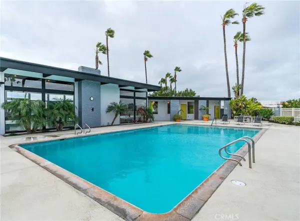 a view of a swimming pool with a table and chairs