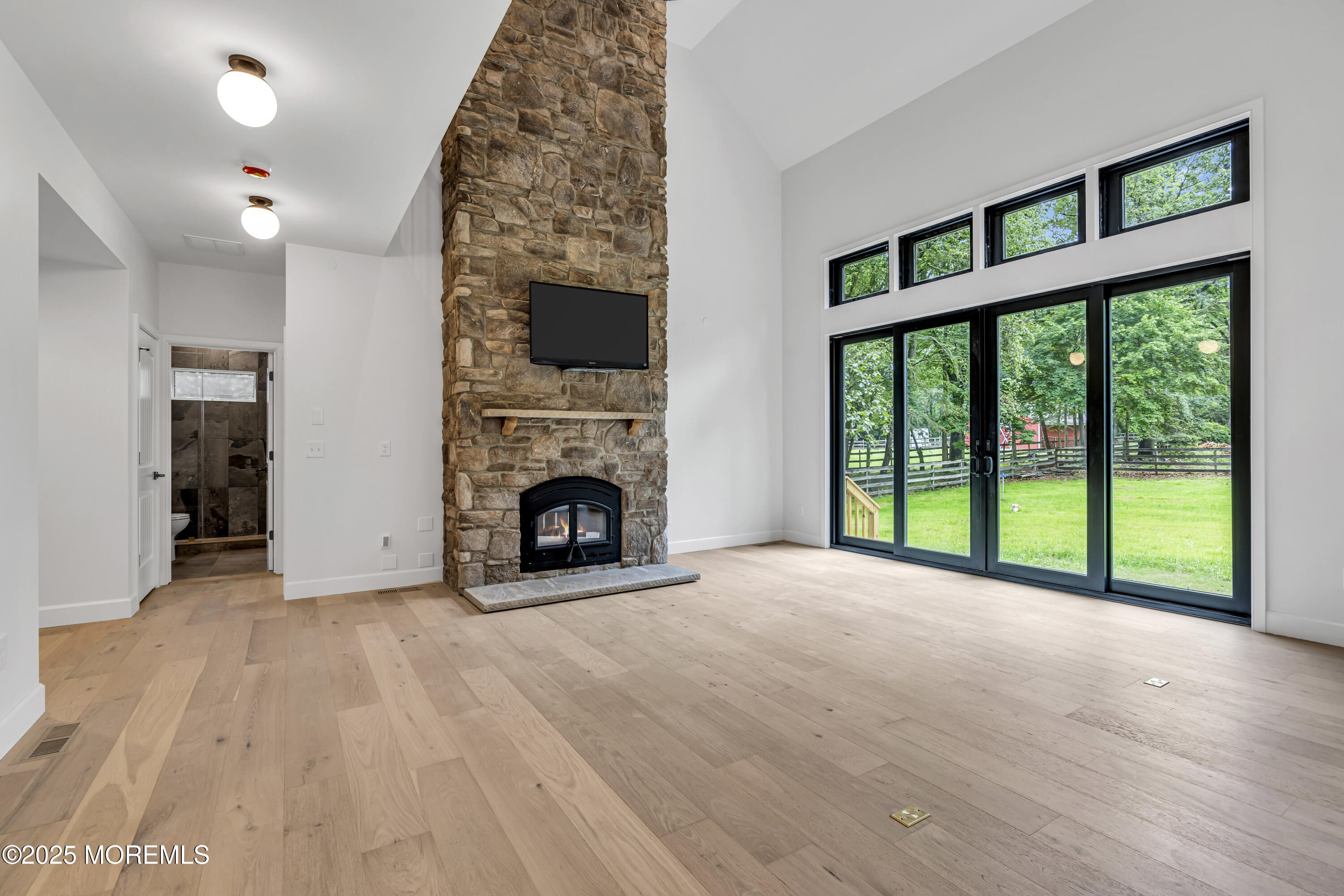 379 Buckalew Road Freehold, NJ 07728 - Photo 22 of 83 a view of an empty room with a fireplace and a window