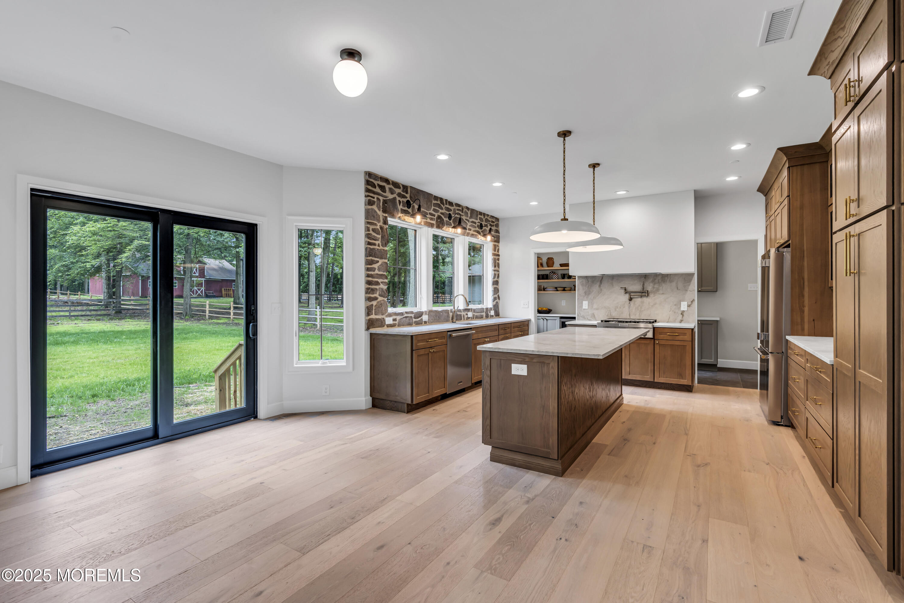 379 Buckalew Road Freehold, NJ 07728 - Photo 26 of 83 a large kitchen with stainless steel appliances kitchen island granite countertop a large counter top a stove a sink and a refrigerator