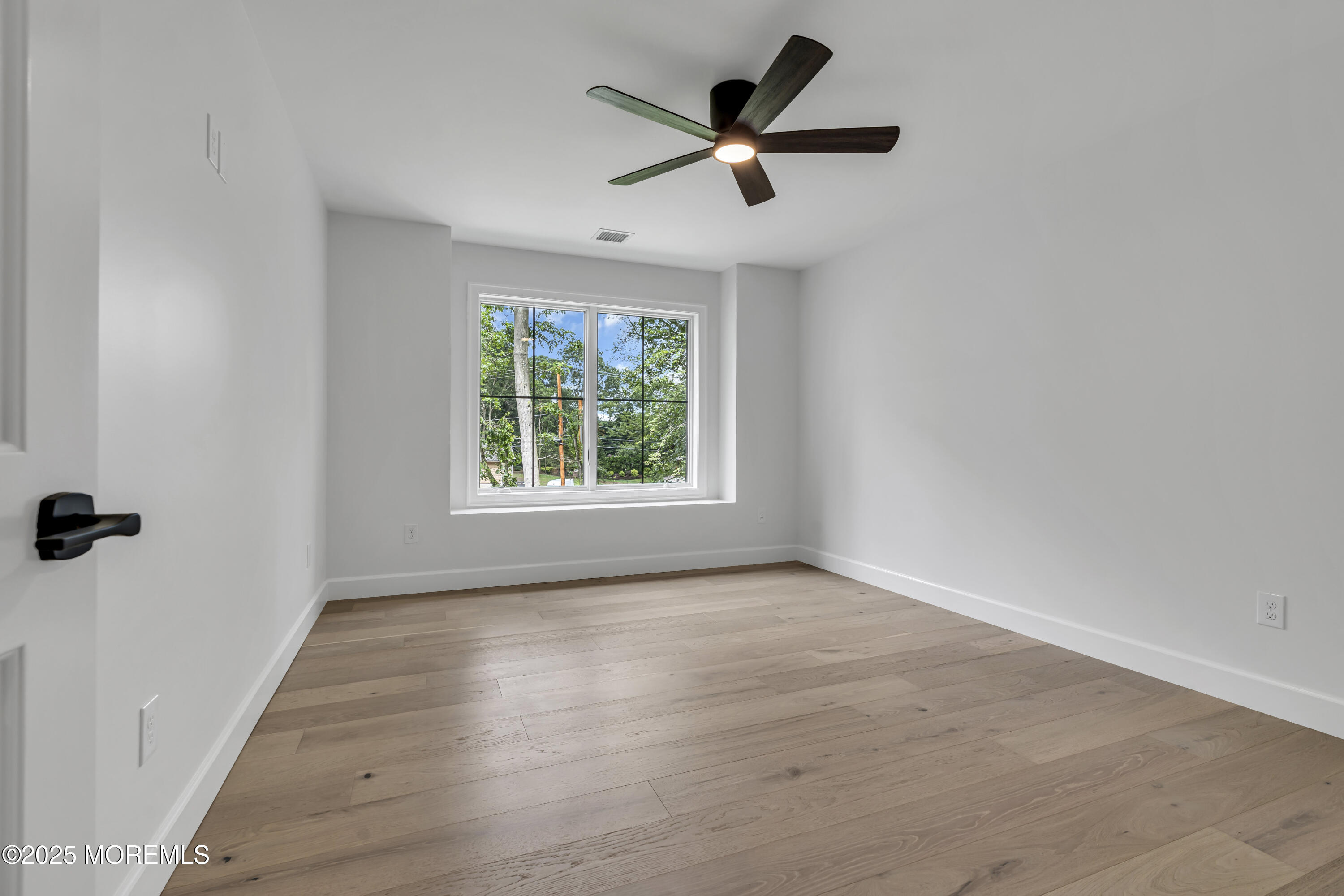 379 Buckalew Road Freehold, NJ 07728 - Photo 53 of 83 wooden floor in an empty room with a window