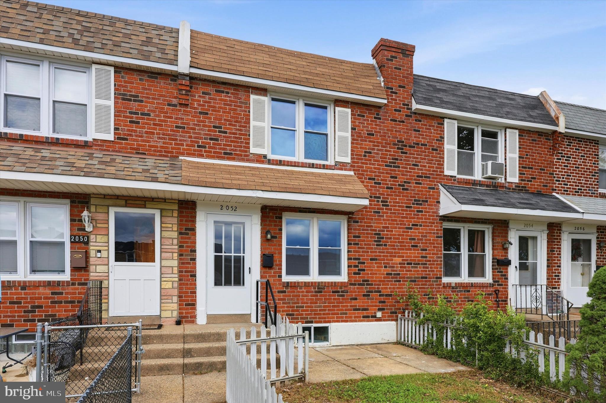 2052 Heather Road Folcroft, PA 19032 - Photo 1 of 17 front view of a brick house with a yard and table and chairs