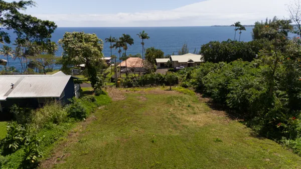 an aerial view of a house with a yard basket ball court and outdoor seating
