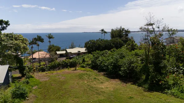 an aerial view of a house with yard