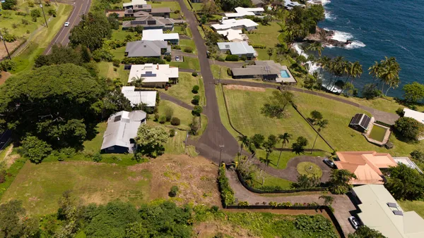 an aerial view of a house with a swimming pool