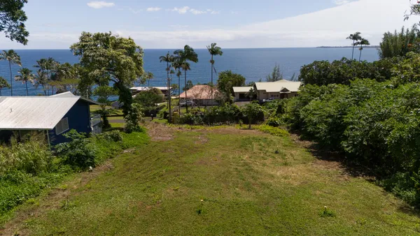 an aerial view of a house with a yard basket ball court and outdoor seating