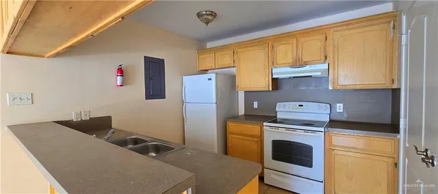 a kitchen with appliances cabinets and a sink