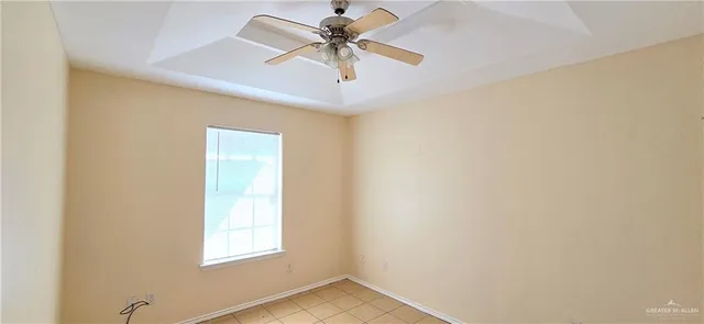 a view of a room with a window and a ceiling fan