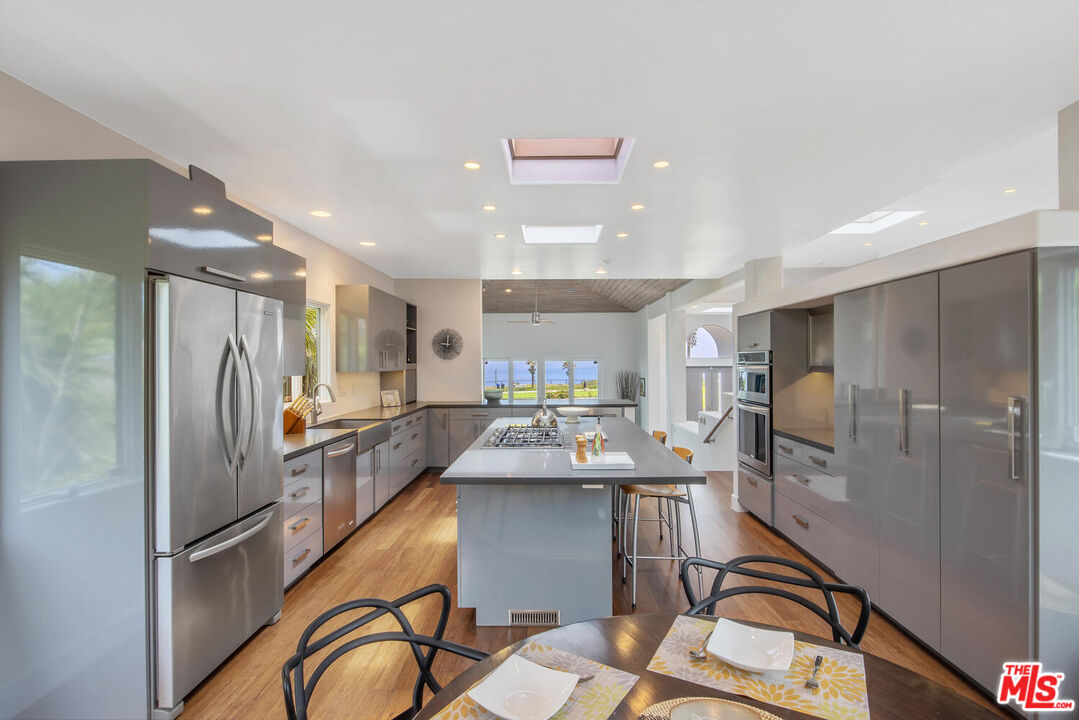 1312 Shoreline Drive Santa Barbara, CA 93109 - Photo 21 of 67 a kitchen with stainless steel appliances kitchen island granite countertop a refrigerator stove top oven and sink
