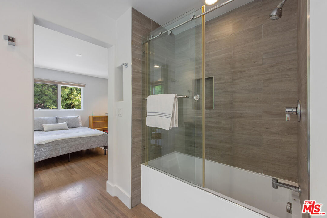 1312 Shoreline Drive Santa Barbara, CA 93109 - Photo 50 of 67 a bathroom with a tub shower and sink