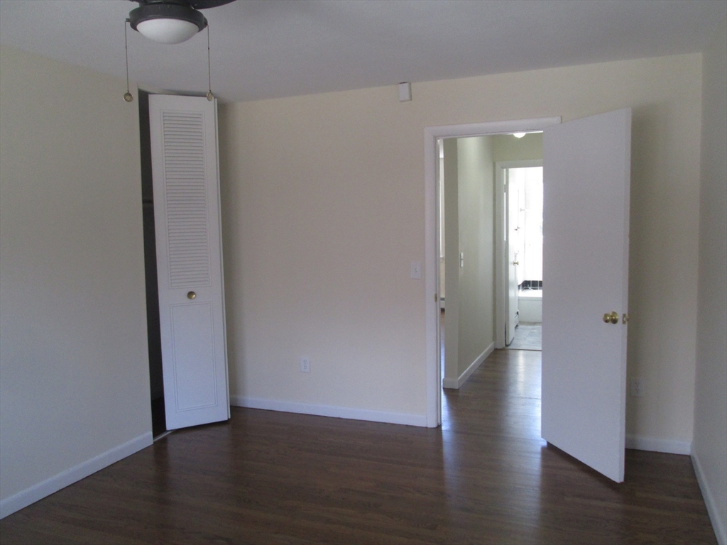 119 Colonial Circle, Unit B Chicopee, MA 01020 - Photo 11 of 17 a view of an empty room with wooden floor