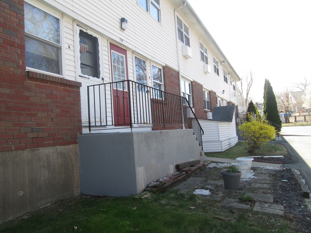 119 Colonial Circle, Unit B Chicopee, MA 01020 - Photo 14 of 17 a view of a blue house with many windows and a yard