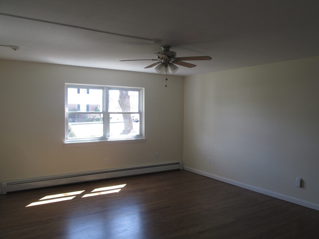 119 Colonial Circle, Unit B Chicopee, MA 01020 - Photo 4 of 17 wooden floor in an empty room with a window